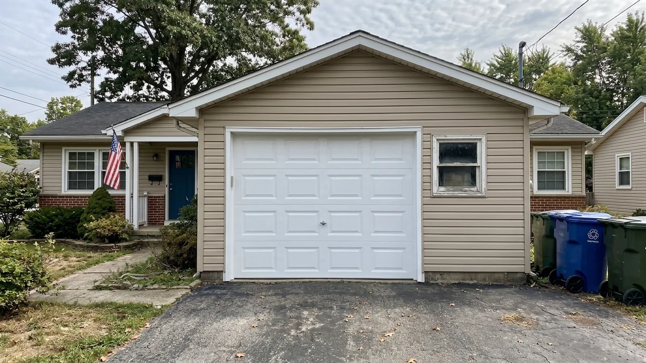 After: a new white sectional garage door on the same home